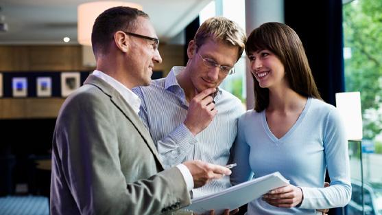 3 business people reading off paper