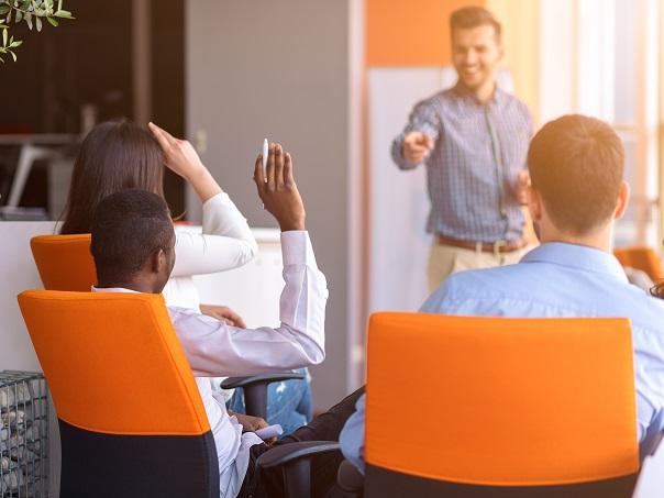 Male and female asking questions in meeting