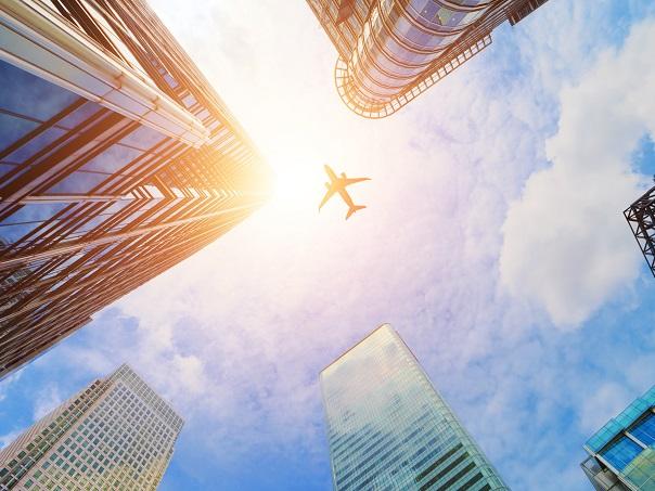 Plane flying over buildings