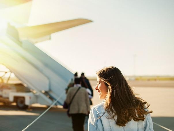 Female walking onto plane