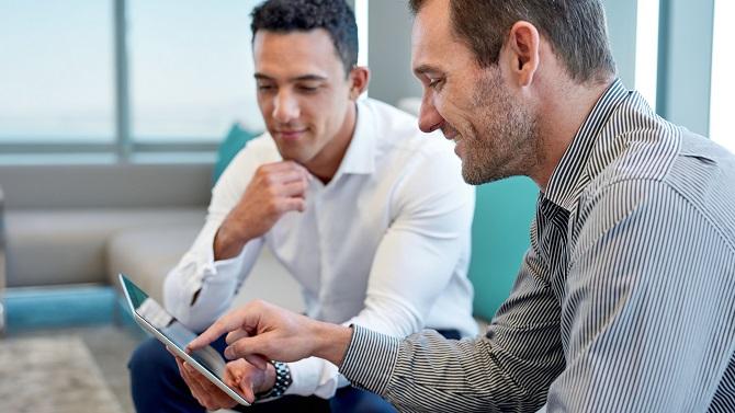 Two males looking at iPad