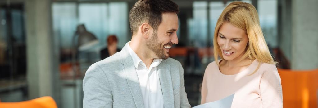 Two business professionals looking at travel expenses