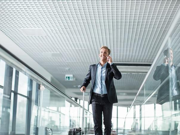 Male walking in airport on phone