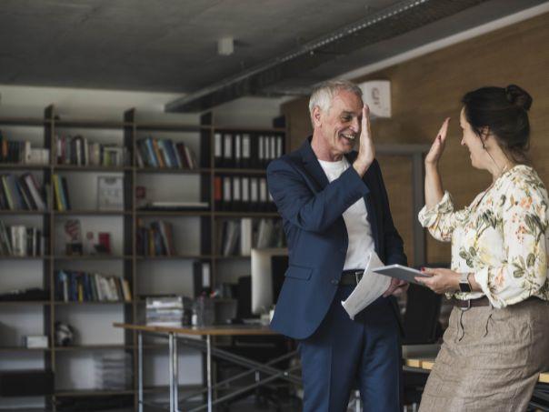 Two business human high fiving