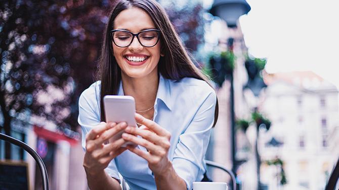 Female smiling while on phone